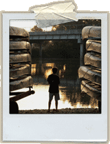 picture of a boy next to canoes